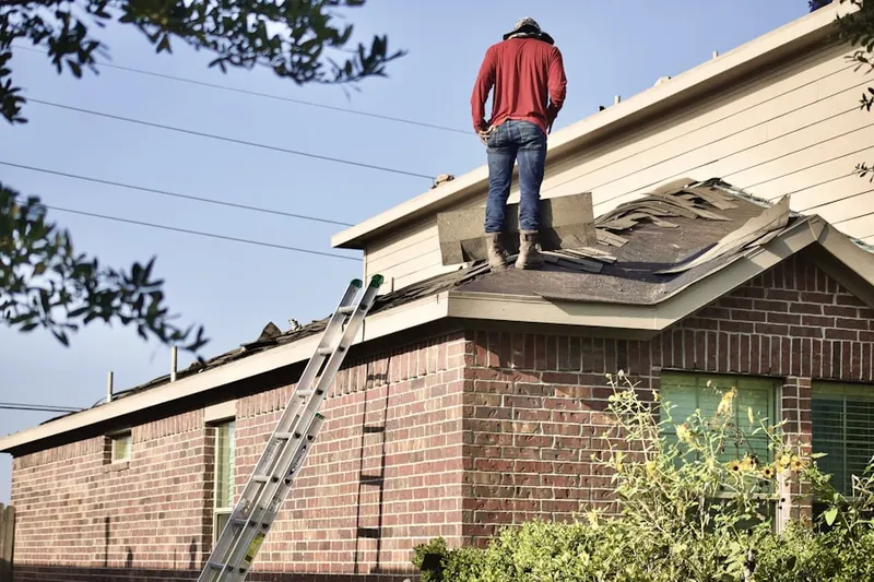 Professional roofer working on a residential roof in Sedgewood